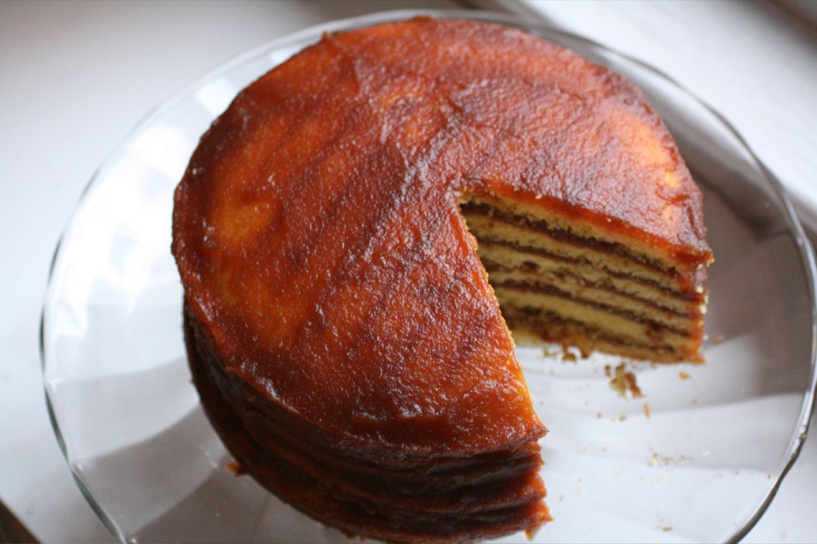 A tall Appalachian apple stack cake of many thin layers with dark dried-apple filling, sliced to show the stripes.