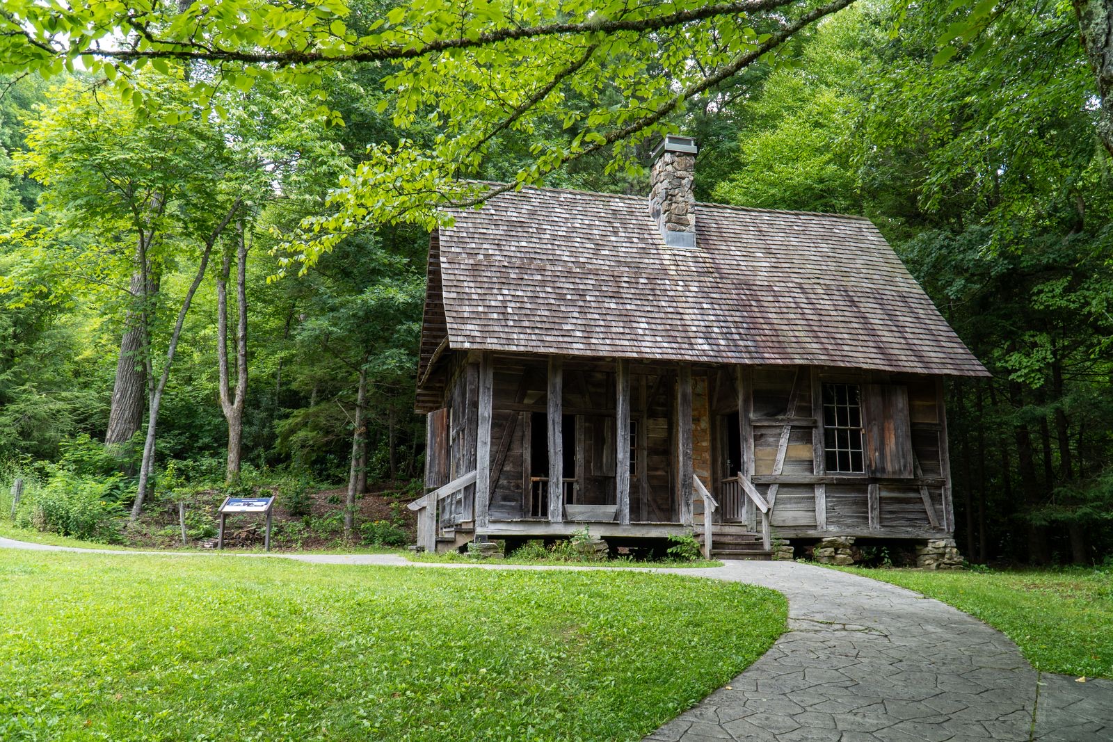 A historic log cabin set in green mountain forest along the Blue Ridge.