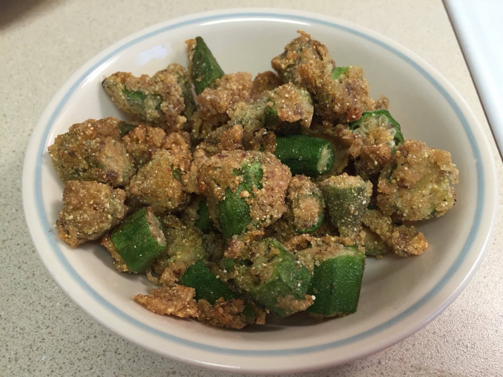 A bowl of cornmeal-coated fried okra.
