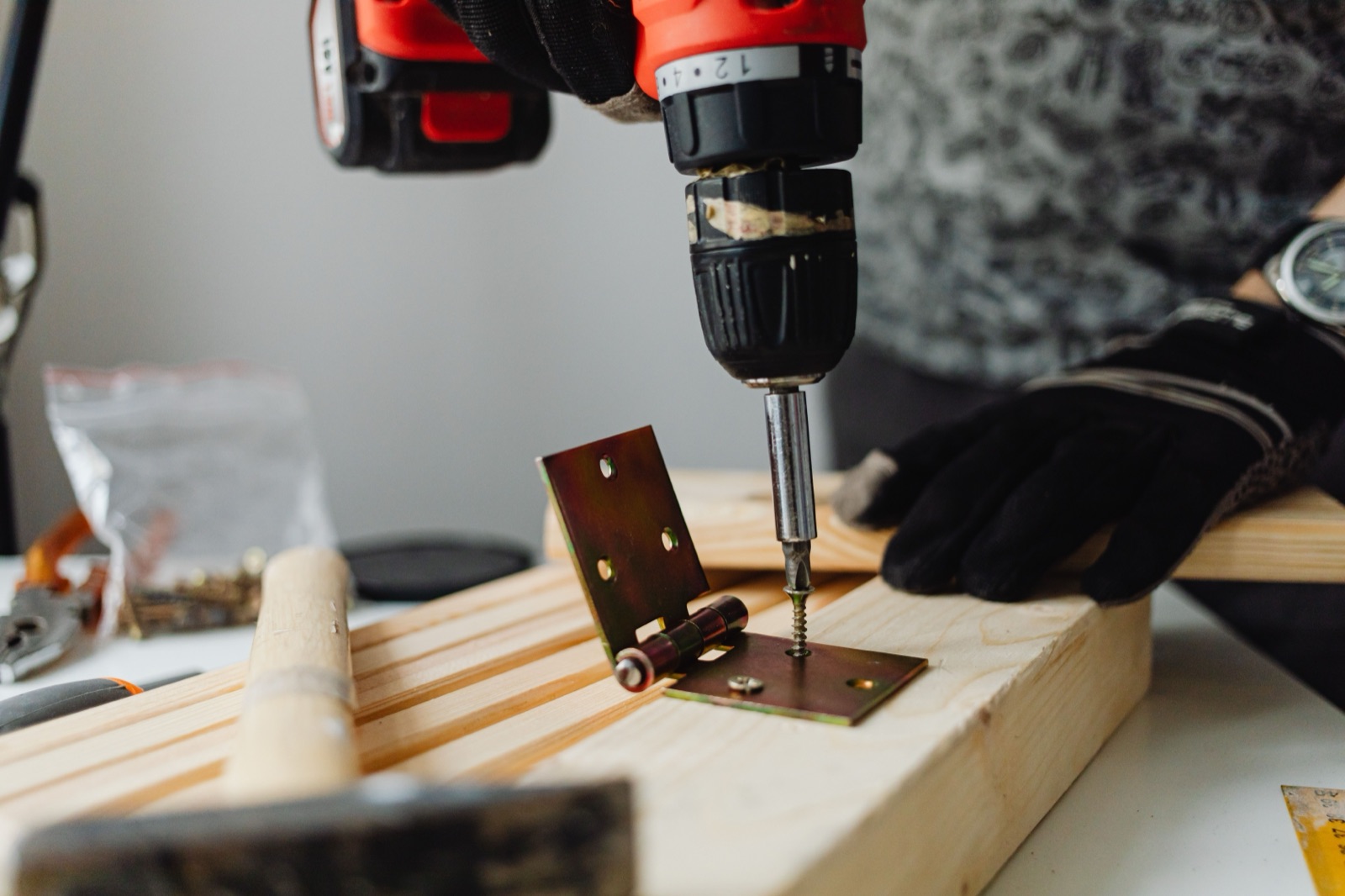 A hinge being installed with a drill, the kind of small fix an old hardware store is built around.