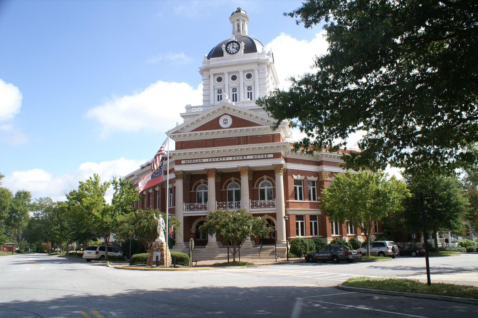 The historic brick Morgan County Courthouse with its clock tower on the Madison, Georgia town square.