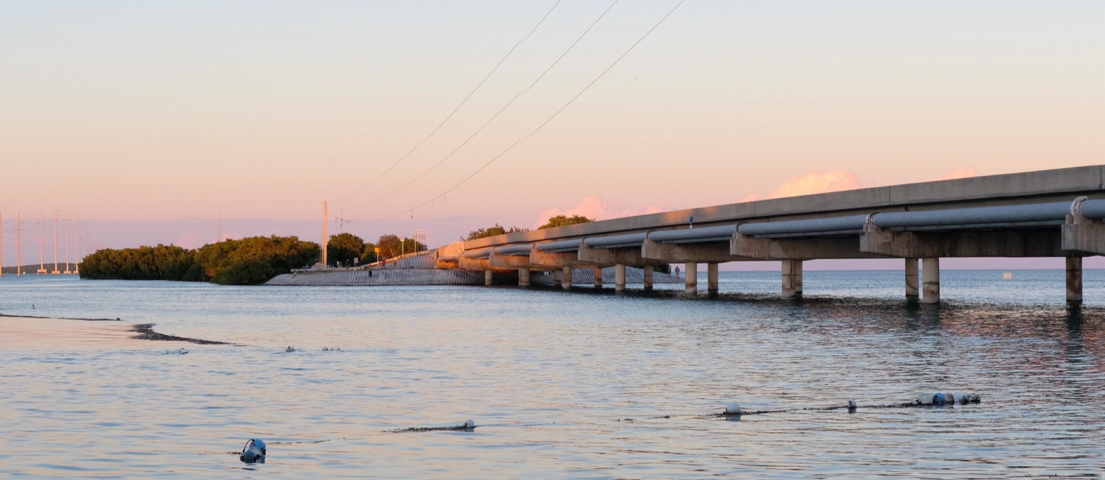 The Overseas Highway crossing open water between the Florida Keys at dusk.
