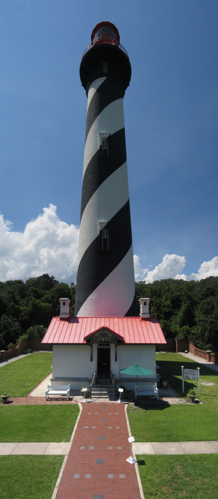 The black-and-white spiral-striped St. Augustine Lighthouse with its red lantern on Anastasia Island, Florida.